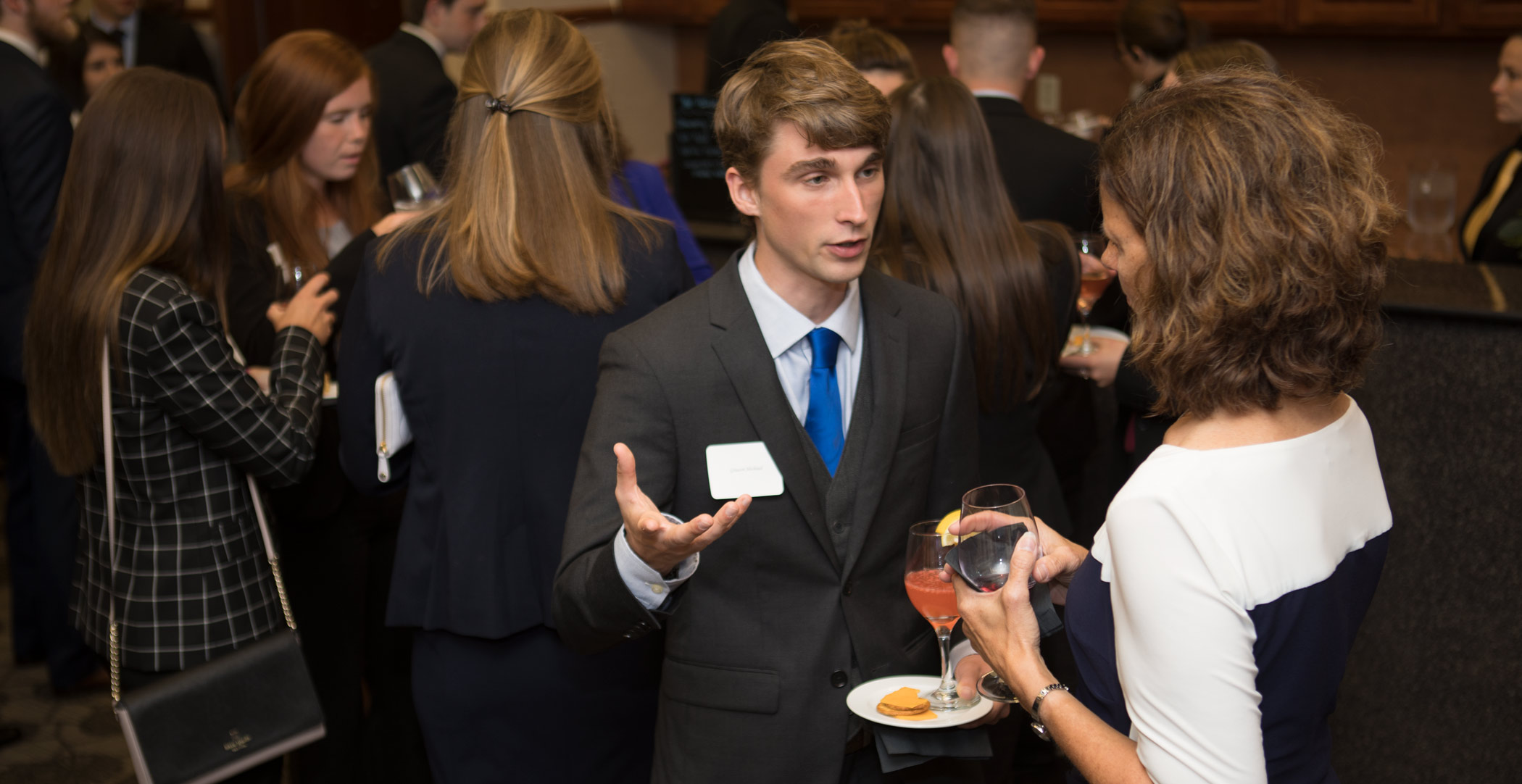 Patty Navin speaks with Graeson Michaud. «Ӱҵ Dicke College of Business Administration juniors participated in an etiquette dinner at The Inn at «Ӱҵ.